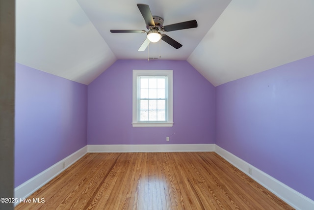 additional living space featuring ceiling fan, vaulted ceiling, baseboards, and wood finished floors