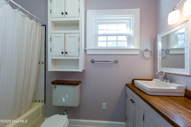 bathroom with shower / bath combination with curtain, vanity, and toilet