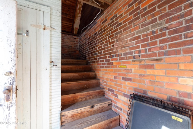 staircase with brick wall