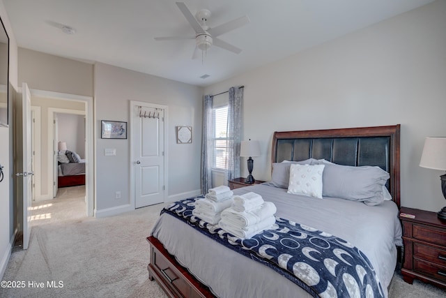 bedroom featuring ceiling fan and light carpet