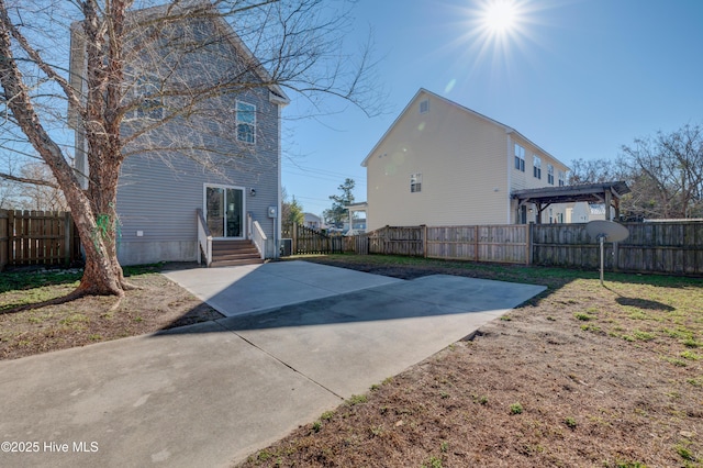 back of house with a yard and a patio