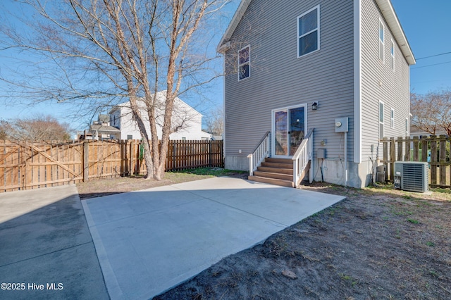 rear view of house featuring a patio and central air condition unit