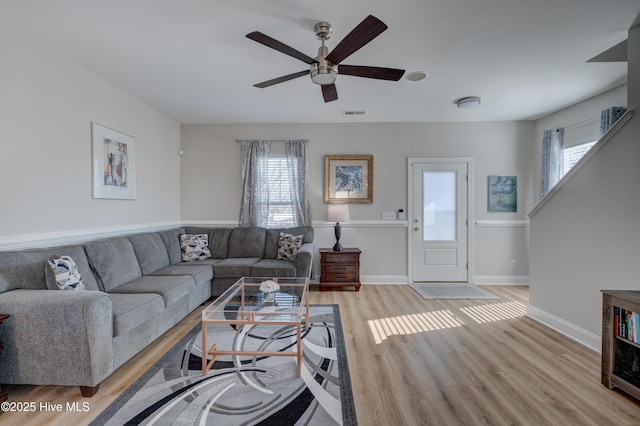 living room featuring ceiling fan and light hardwood / wood-style flooring