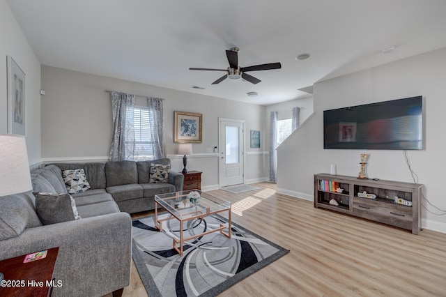 living room with light hardwood / wood-style floors and ceiling fan