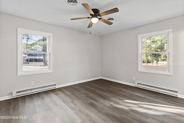 unfurnished room with ceiling fan, baseboard heating, and dark wood-type flooring