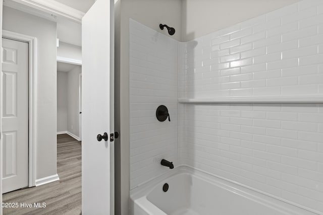 bathroom featuring wood-type flooring and  shower combination