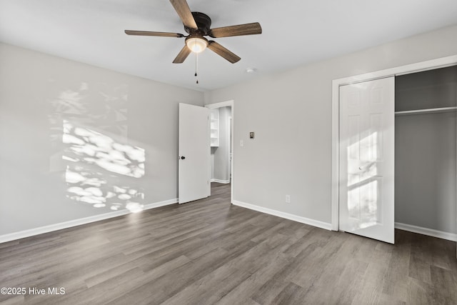 unfurnished bedroom featuring hardwood / wood-style floors, ceiling fan, and a closet