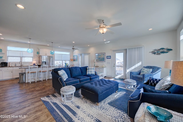 living room with ceiling fan, dark wood-type flooring, and sink