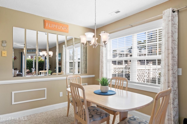 dining space with an inviting chandelier