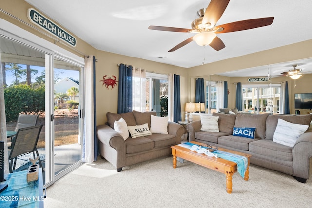 carpeted living room featuring plenty of natural light and ceiling fan