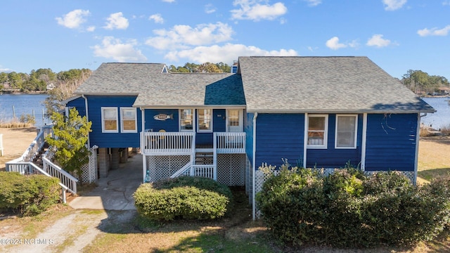 view of front facade with a water view and a carport