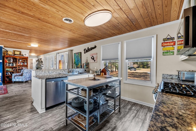 kitchen featuring light stone countertops, sink, stainless steel appliances, dark hardwood / wood-style floors, and ornamental molding