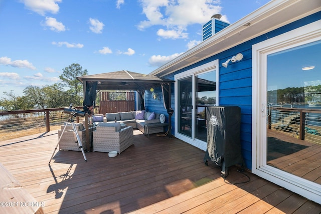 wooden terrace featuring outdoor lounge area and a gazebo