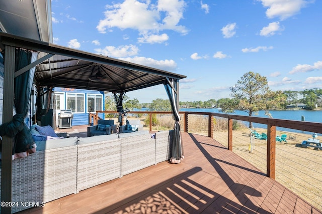 wooden terrace featuring a gazebo, grilling area, an outdoor living space, and a water view