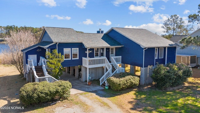 view of front facade featuring covered porch and a carport