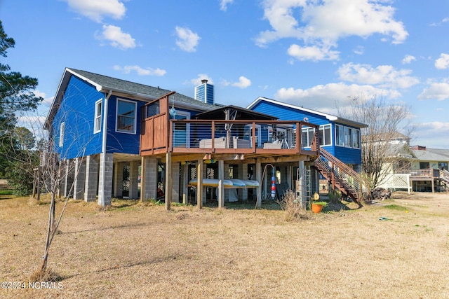 back of property featuring a wooden deck