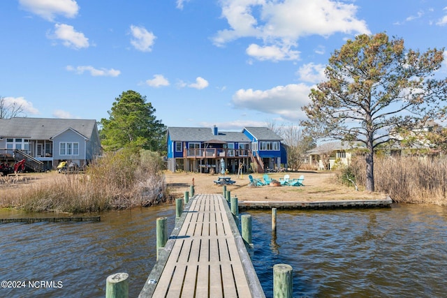 view of dock with a deck with water view