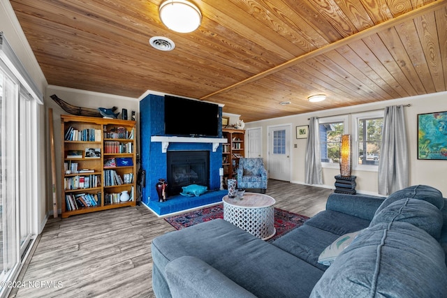 living room featuring hardwood / wood-style floors, ornamental molding, and wood ceiling