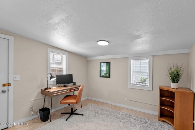 office with light tile patterned floors and a textured ceiling