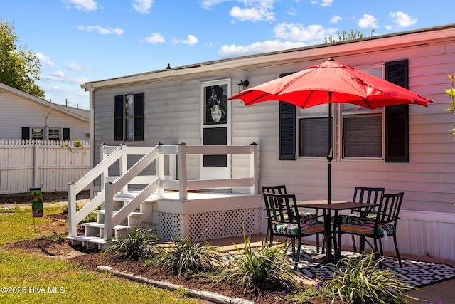 rear view of house with a wooden deck