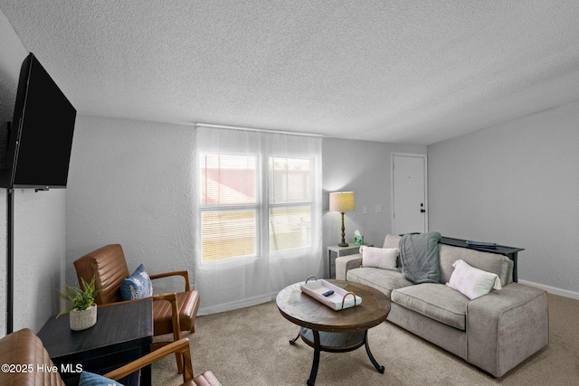 living room featuring carpet and a textured ceiling