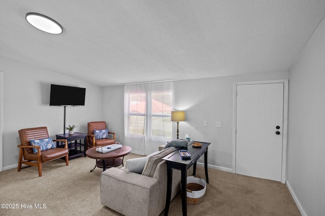 carpeted living room featuring a textured ceiling