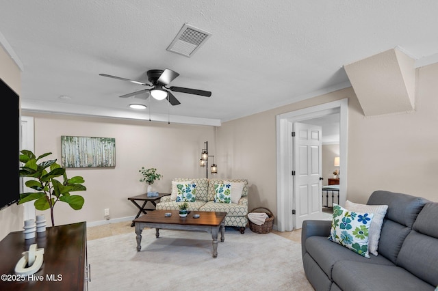 living room featuring ceiling fan and a textured ceiling