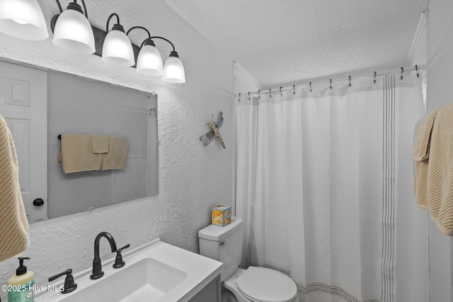 bathroom with vanity, a textured ceiling, and toilet