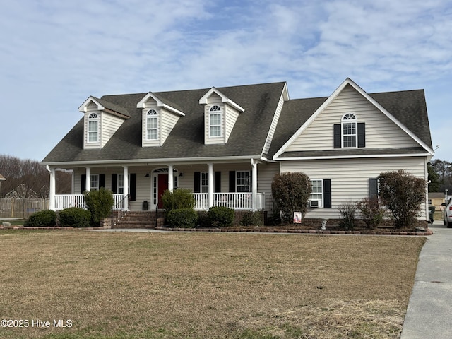 cape cod house featuring a front lawn