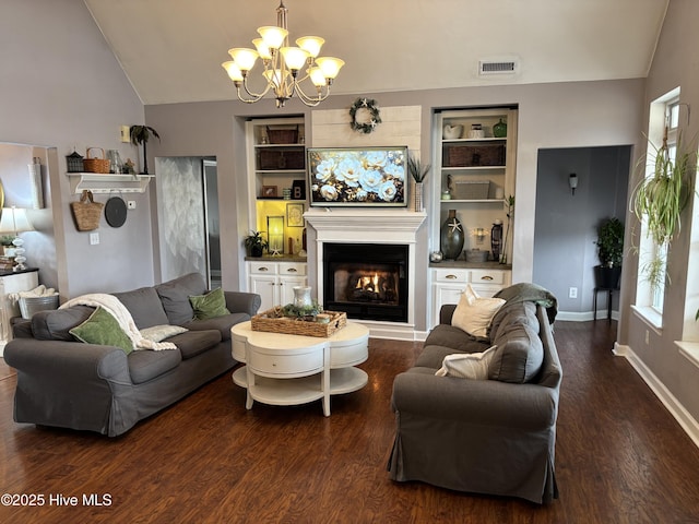 living room featuring vaulted ceiling, dark hardwood / wood-style flooring, built in features, and a chandelier