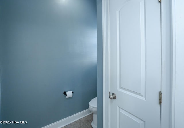 bathroom featuring tile patterned flooring and toilet