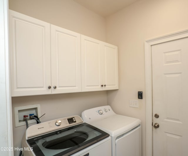 clothes washing area featuring cabinets and independent washer and dryer