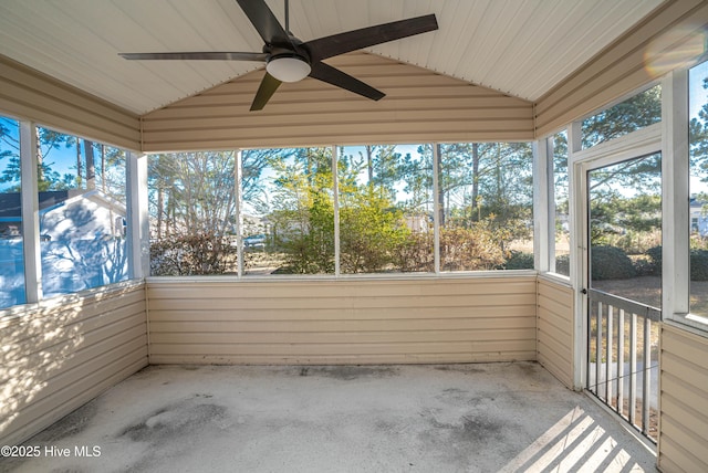 unfurnished sunroom with ceiling fan and vaulted ceiling