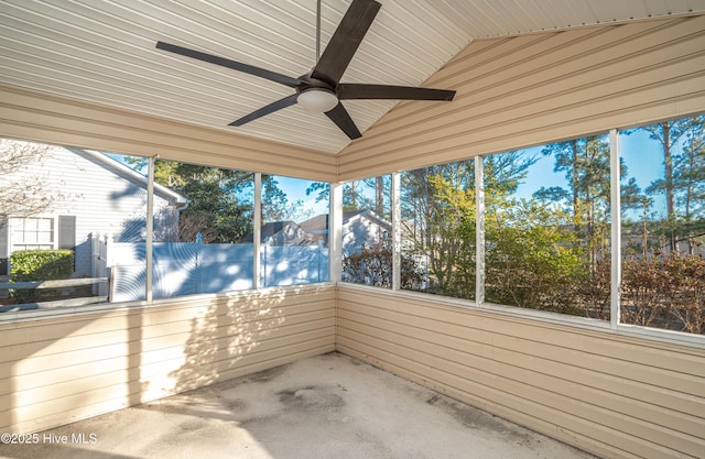 unfurnished sunroom with ceiling fan, wood ceiling, and lofted ceiling