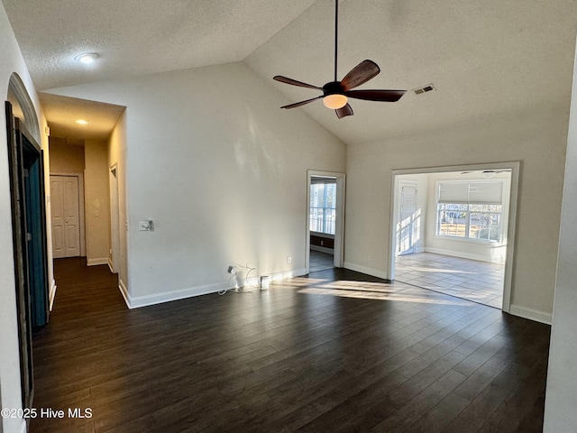 spare room featuring a textured ceiling, lofted ceiling, ceiling fan, and dark hardwood / wood-style floors