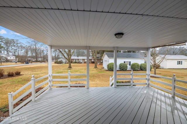 wooden terrace featuring a yard