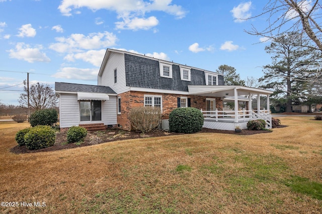 view of front of house with a front yard and a porch