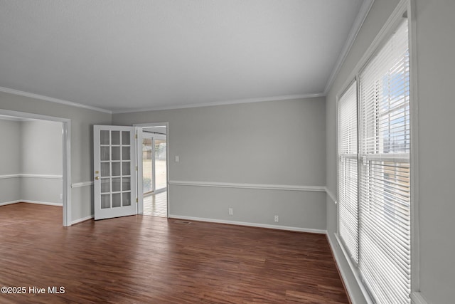 empty room featuring dark hardwood / wood-style flooring and ornamental molding