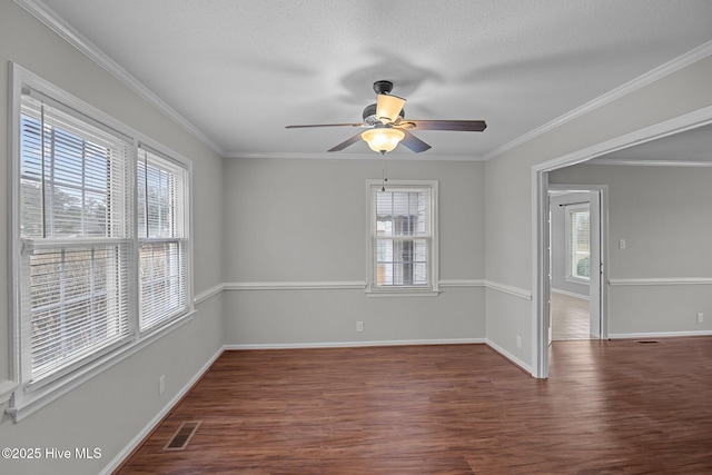 spare room featuring a textured ceiling, ceiling fan, crown molding, and dark hardwood / wood-style floors