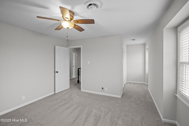 unfurnished bedroom featuring ceiling fan and light carpet