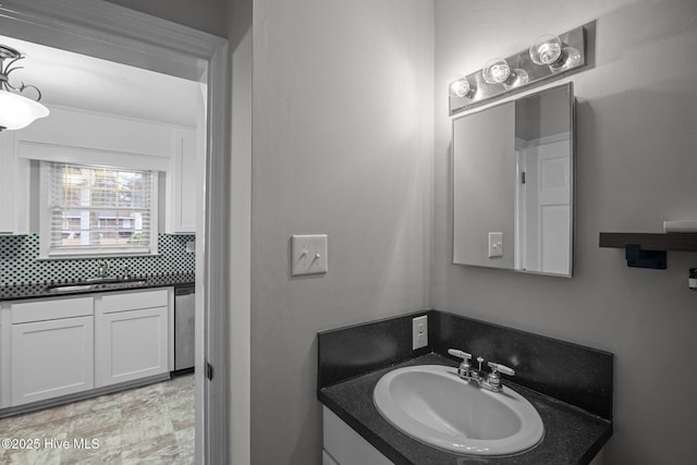 bathroom with vanity and tasteful backsplash