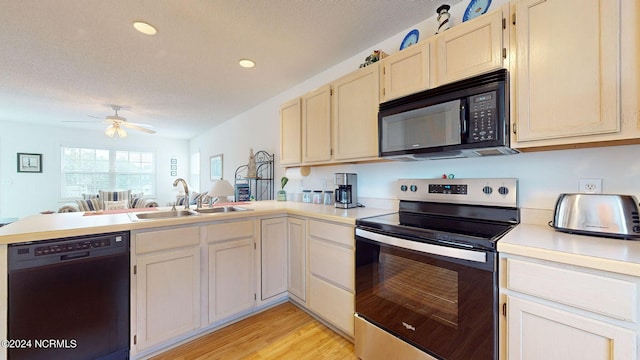 kitchen featuring ceiling fan, sink, light hardwood / wood-style floors, a textured ceiling, and black appliances