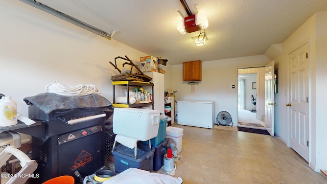 garage with refrigerator and a garage door opener