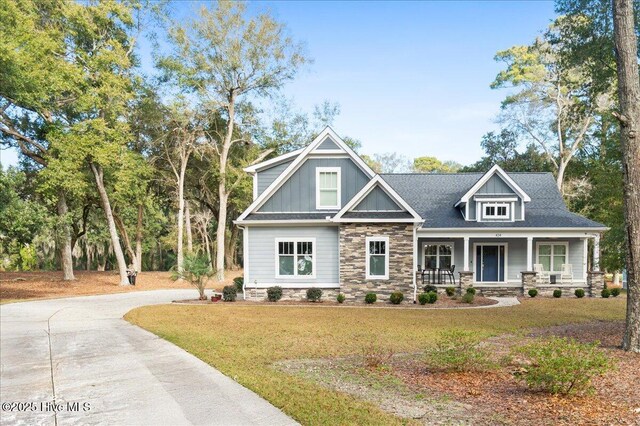 craftsman house with covered porch and a front yard