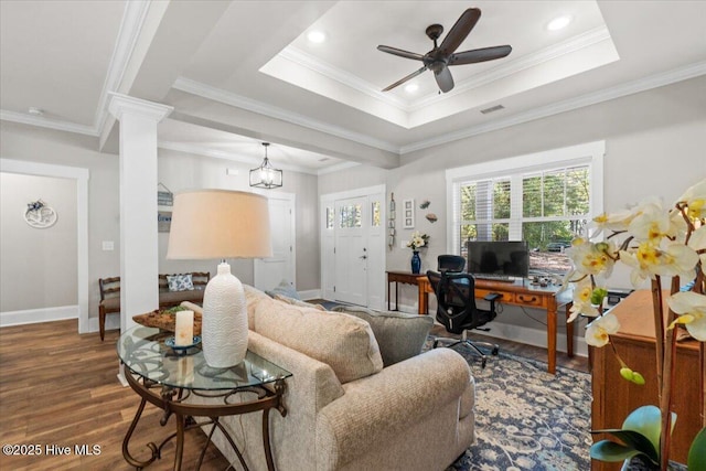 living room featuring visible vents, a raised ceiling, wood finished floors, decorative columns, and baseboards