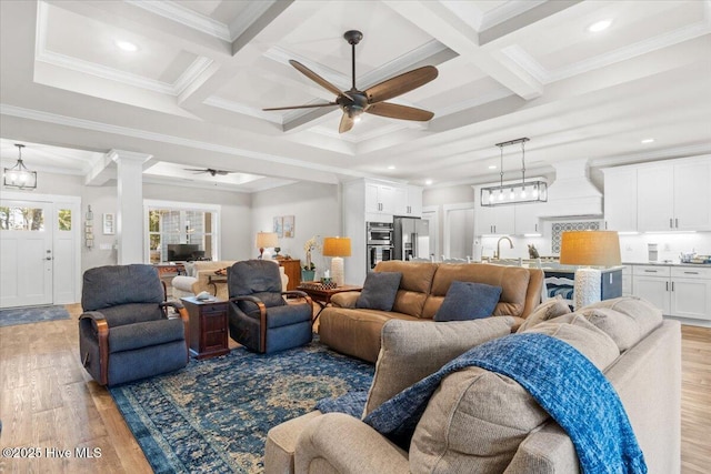 living area featuring beam ceiling, coffered ceiling, and light wood-type flooring