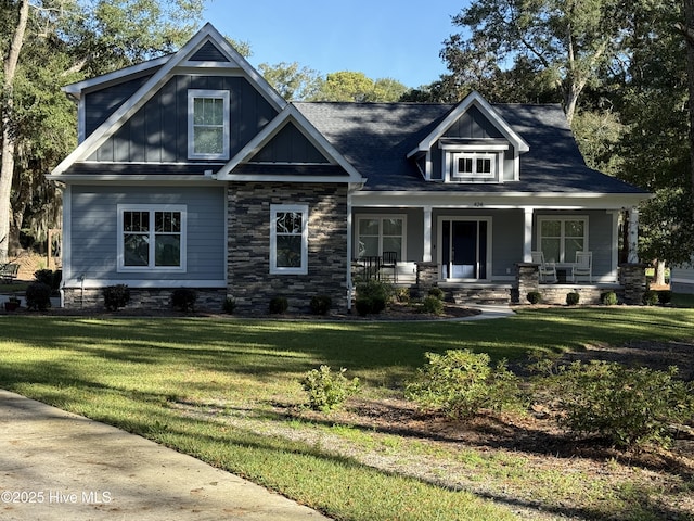 craftsman-style home featuring board and batten siding, a porch, and a front lawn