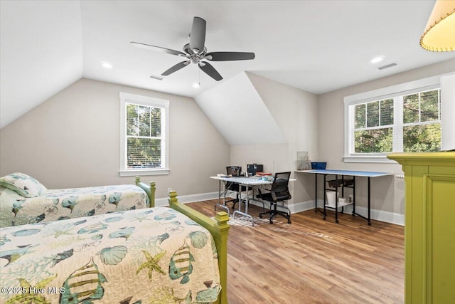 bedroom featuring lofted ceiling, light wood-style flooring, baseboards, and visible vents