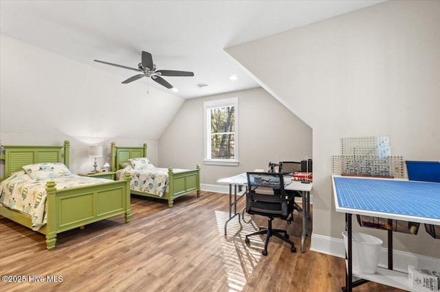 bedroom with baseboards, a ceiling fan, lofted ceiling, and wood finished floors