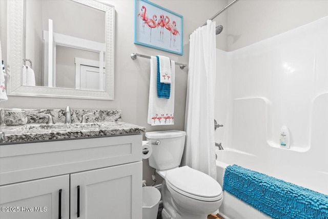 bathroom with toilet, vanity, and shower / tub combo